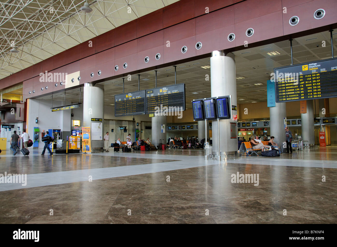 Airport terminal airline arrival and departures board travellers Reina Sofia Airport in southern Tenerife Canary Islands Stock Photo