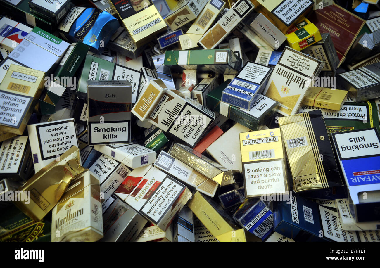 VARIOUS DISGARDED UK  CIGARETTE PACKETS SHOWING WARNING LABELS. Stock Photo