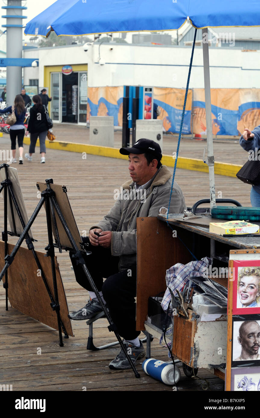 portrait caricature artist waiting sitting for work santa monica pier los angeles county california Stock Photo