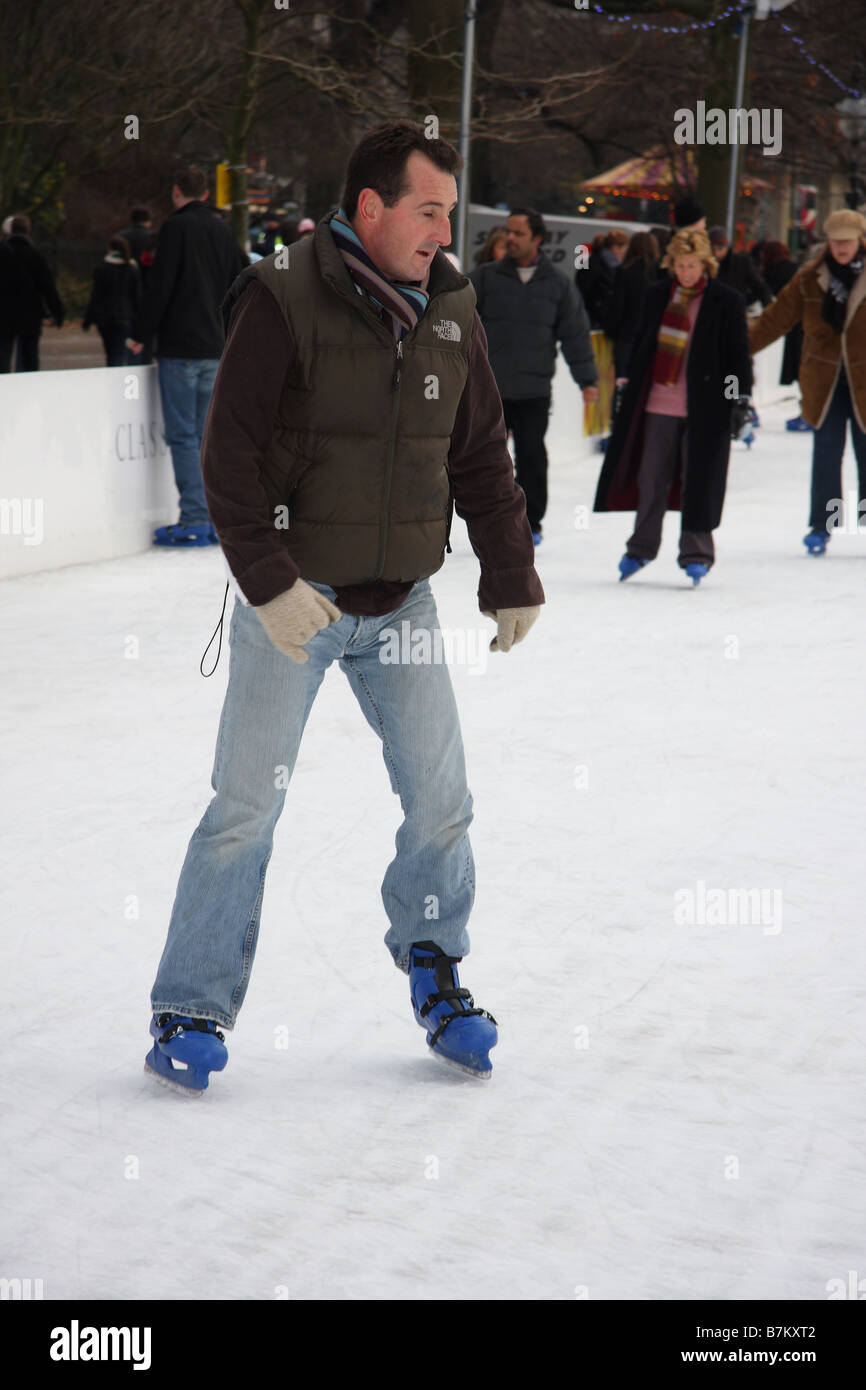 man adult male ice skating skaters rink open air cold winter wonderland