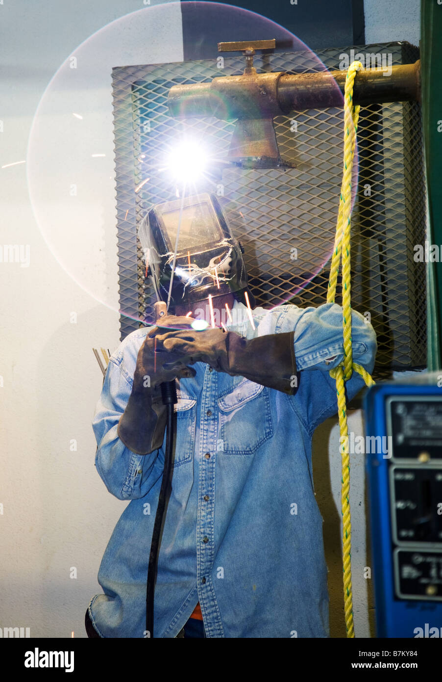 Welder welding a piece of metal overhead The circular glow of the lens
