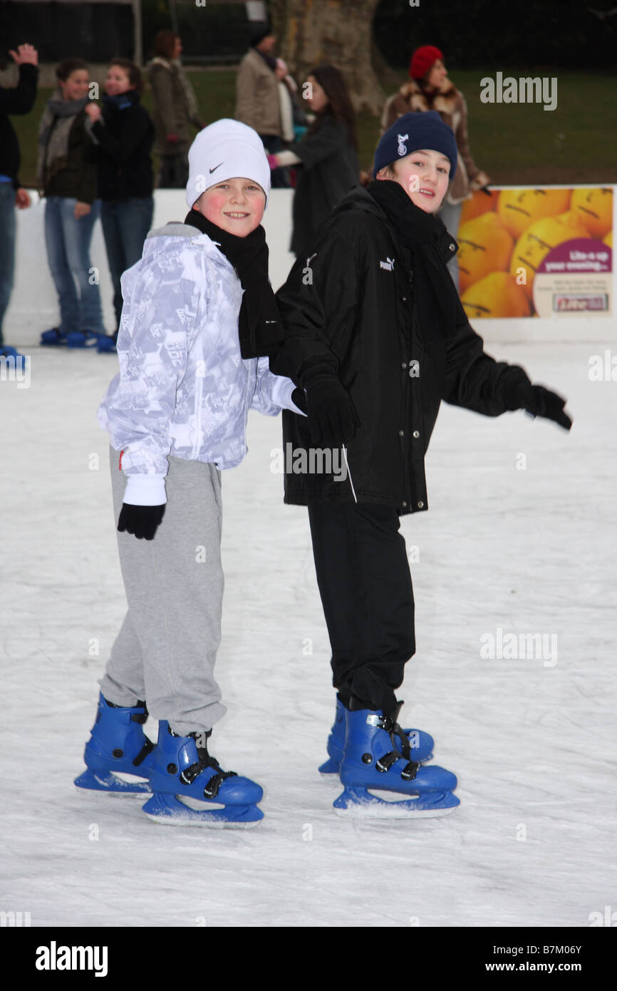 boys teenage brothers ice skating skaters rink open air cold winter