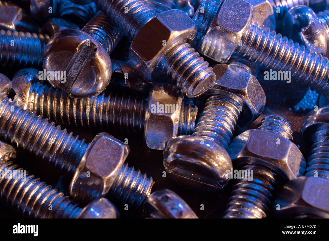 Nuts and Bolts, flat head, blue ,gold, lighting Stock Photo Alamy