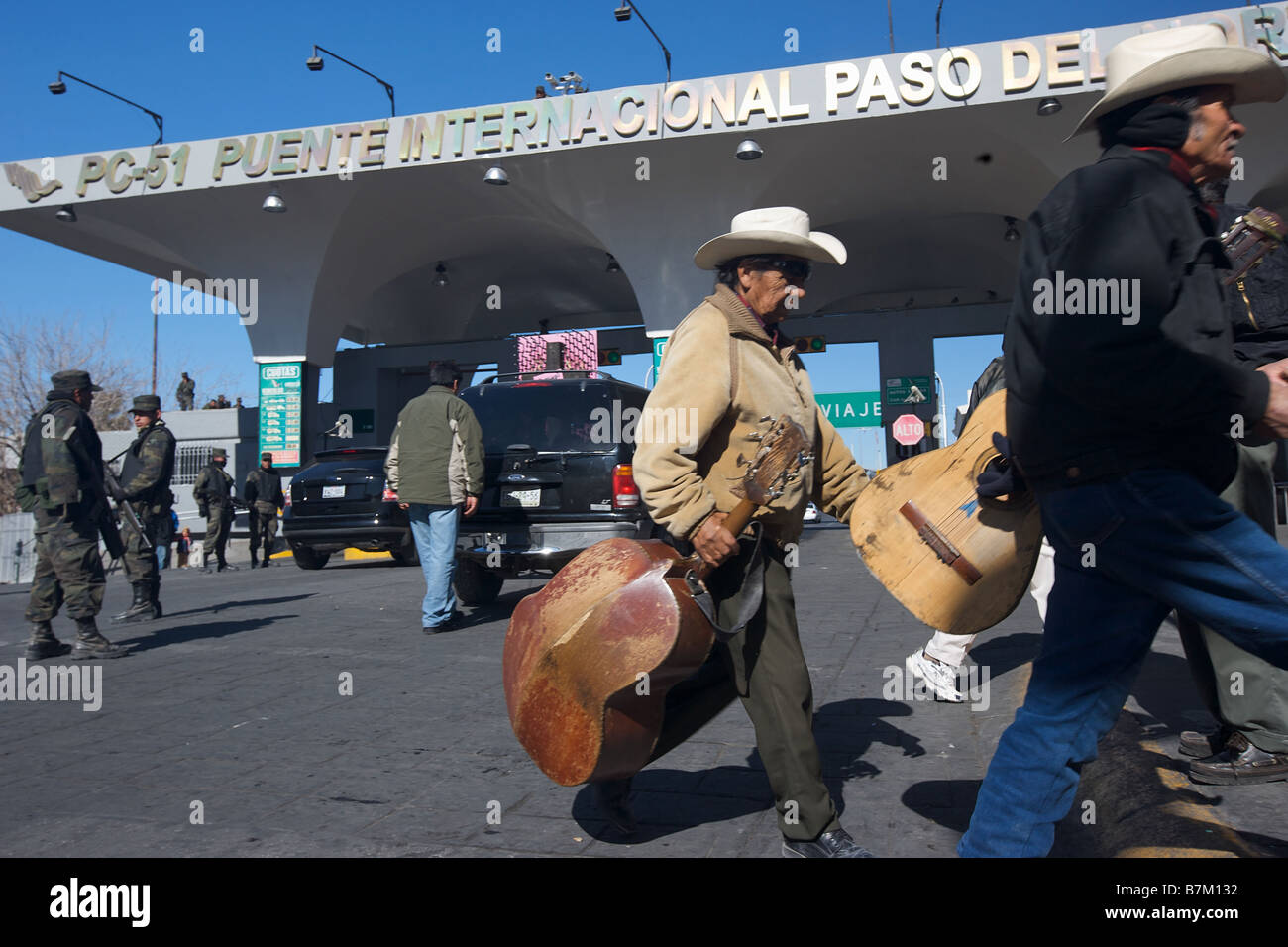 Mexican mariachis players walk past the Santa Fe bridge crossing from Avenue Juarez in Ciudad Juarez Mexico to El Paso Texas Stock Photo