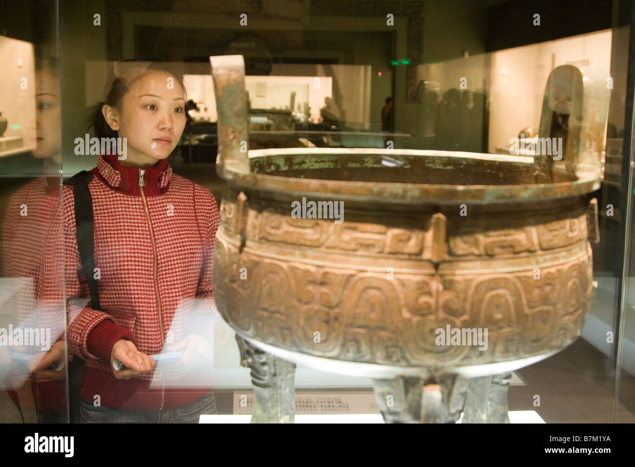 A girl perusing an exhibit at the Shaanxi Historical Museum a large and excellent museum in Xi an Shaanxi province China Stock Photo