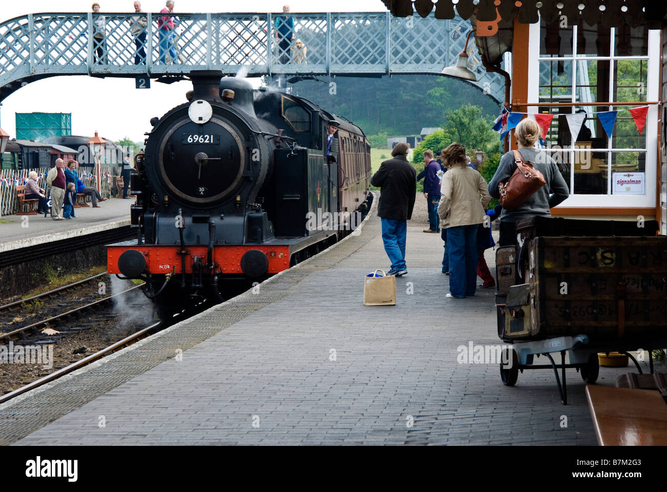 Train approaches station passengers wait hi-res stock photography and ...