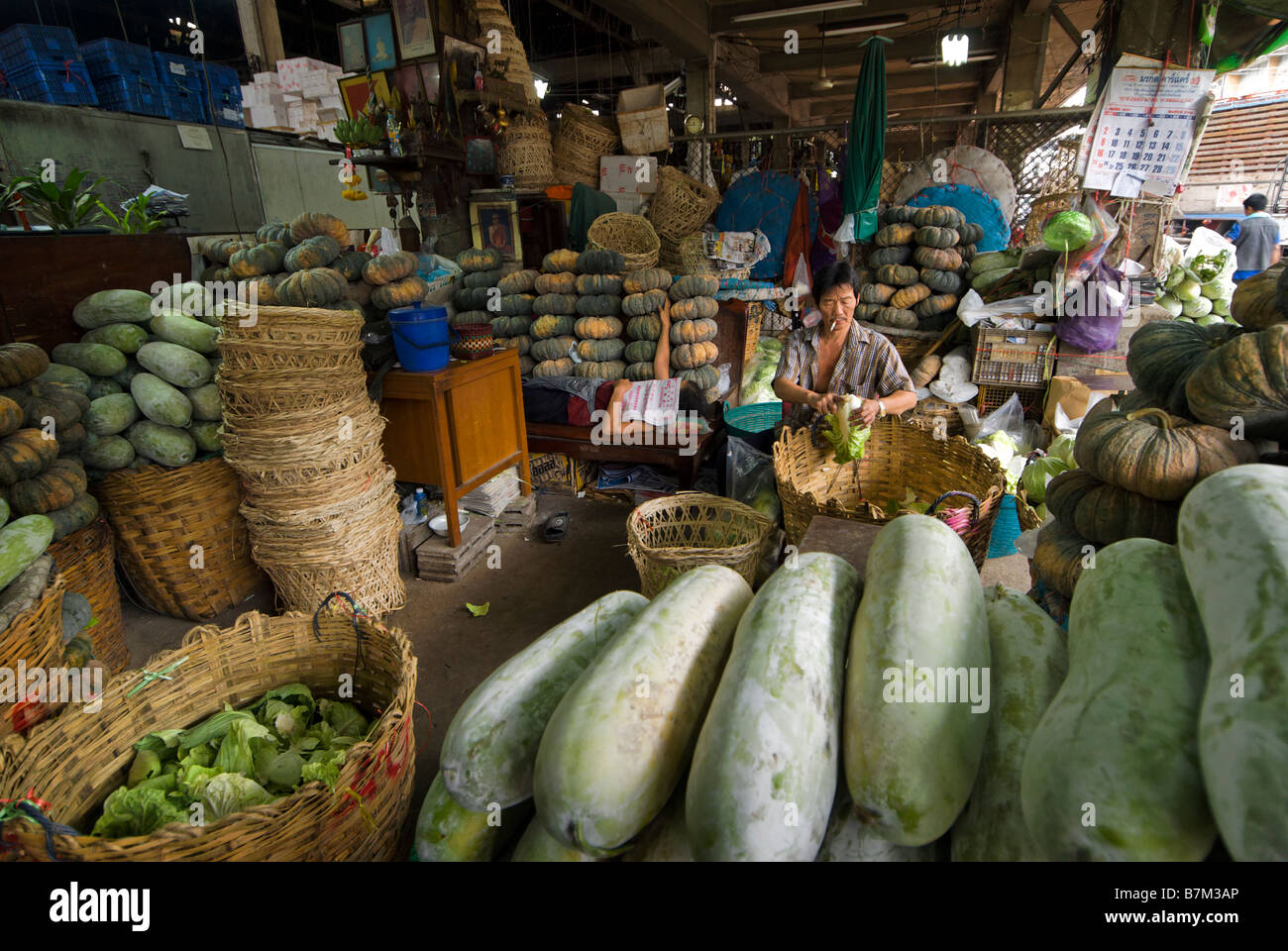Wholesale market vendor trimming lettuces Pak Khlong Talad fresh