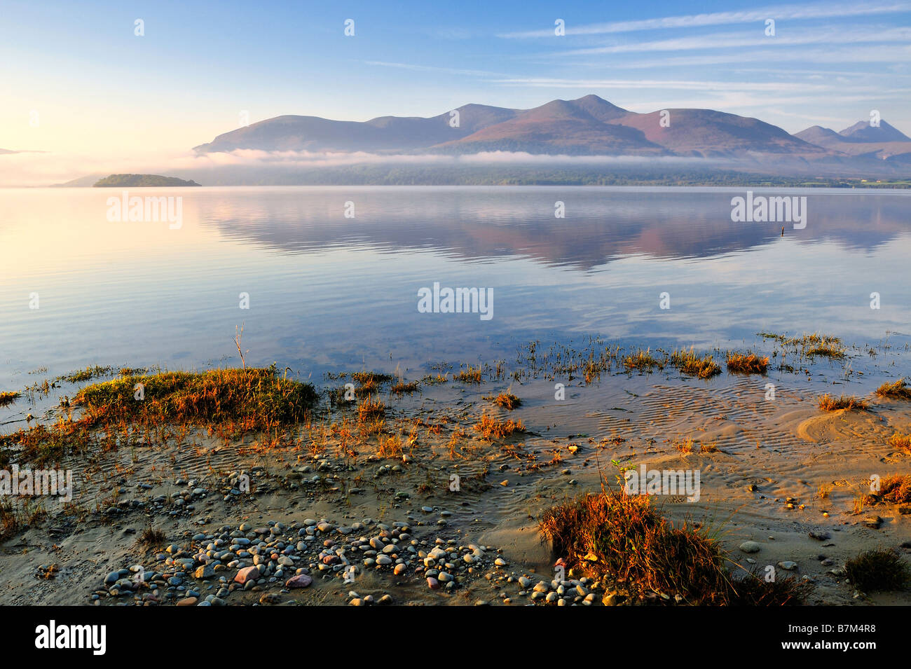 distant mountains reflected in still waters of Killarney Lakes Co Kerry Ireland Stock Photo