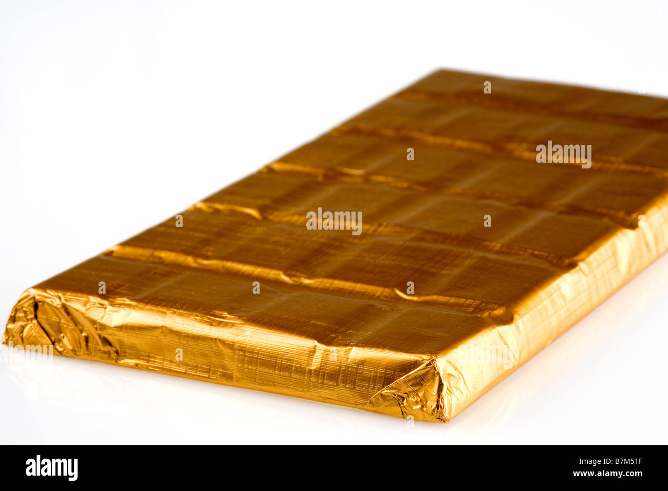 Chocolate bar in gold foil Stock Photo Alamy