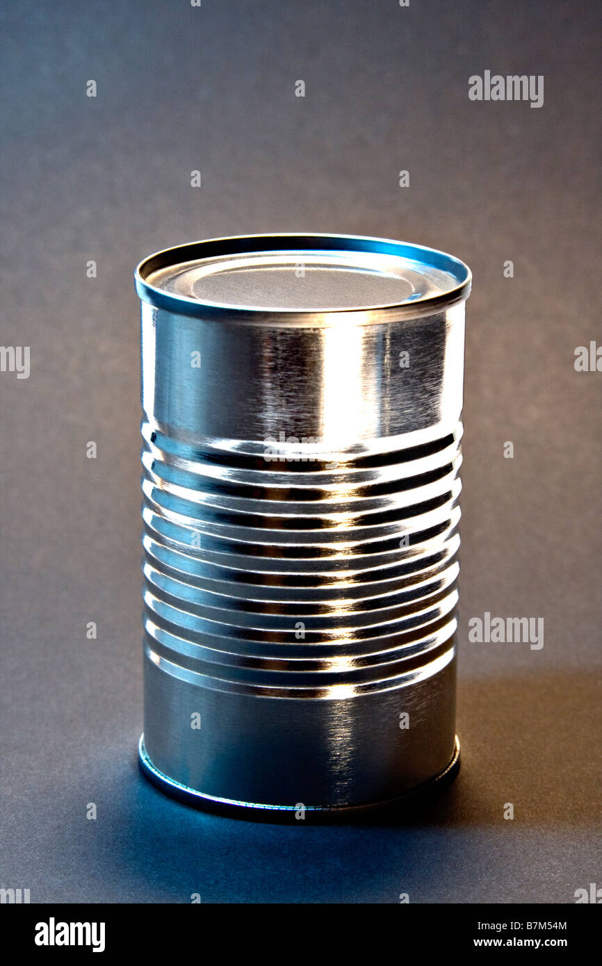 Unopened Tin Can without label on a gray background. Stock Photo