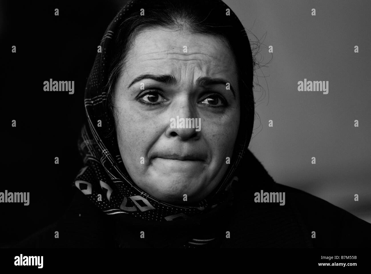 A Palestinian woman resident of Gaza Strip looks worried soon after entering Israel at the Erez border crossing with Israel on January 02 2009 Stock Photo
