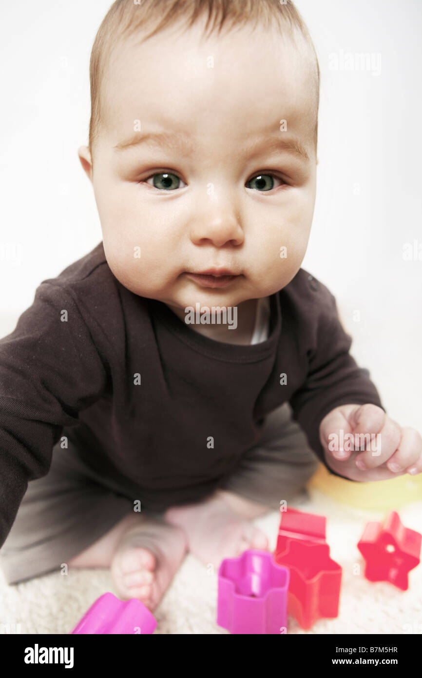 Baby 4 month old sitting on a carpet Stock Photo - Alamy