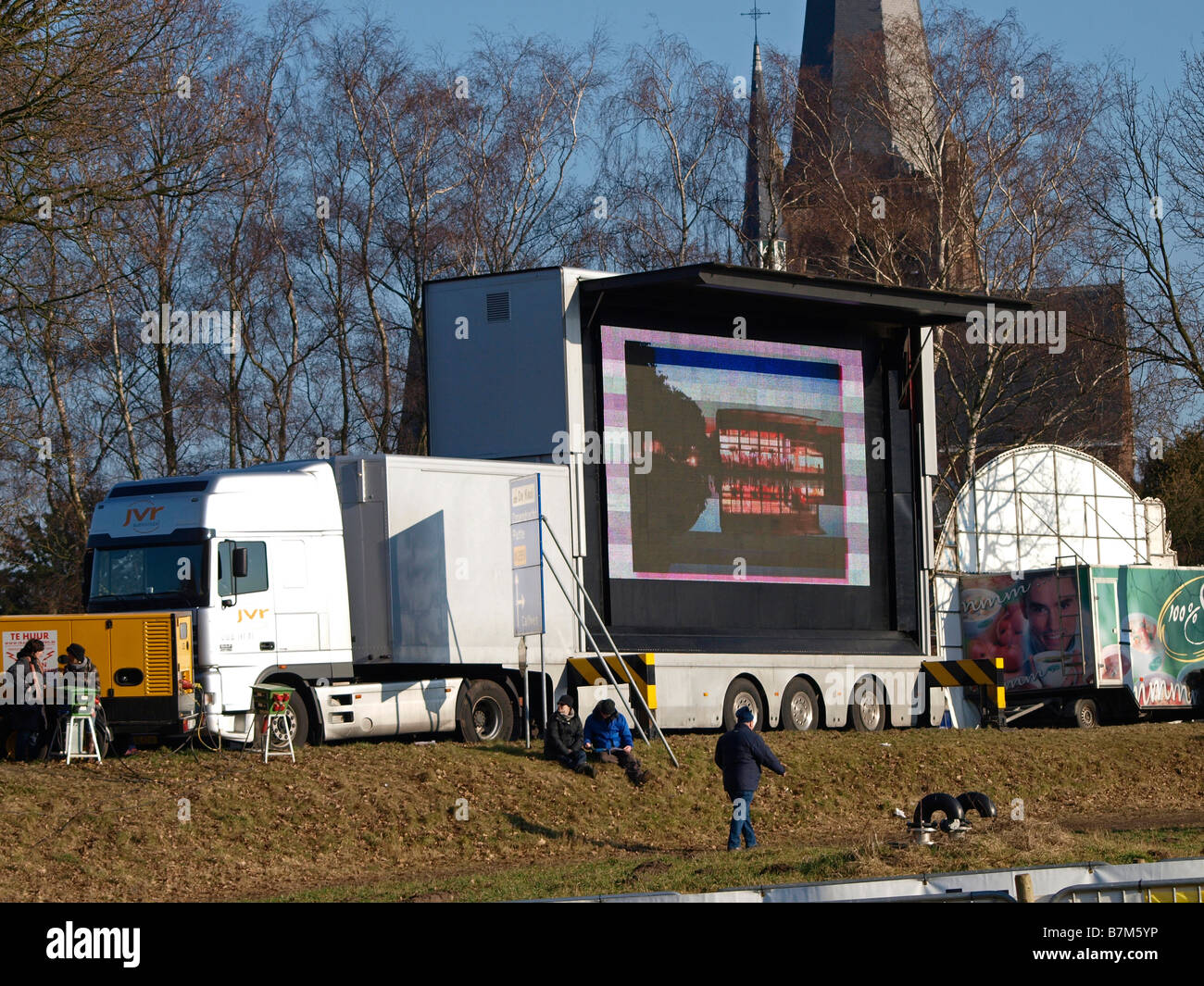 Big truck with extremely large tv screen display mounted on it to show images to large crowds Stock Photo