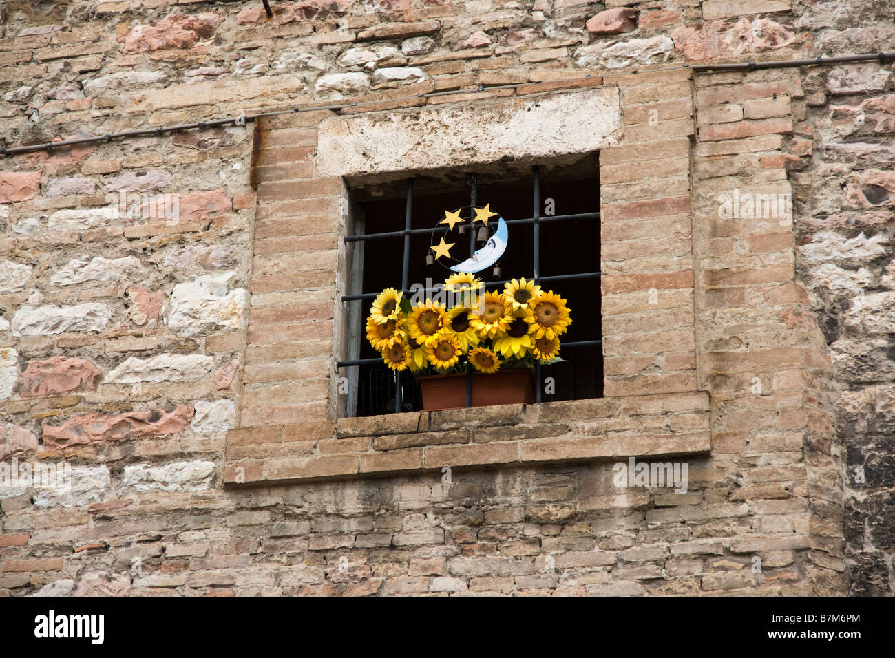 Small window with a Moon and Sunflower ornament. Stock Photo