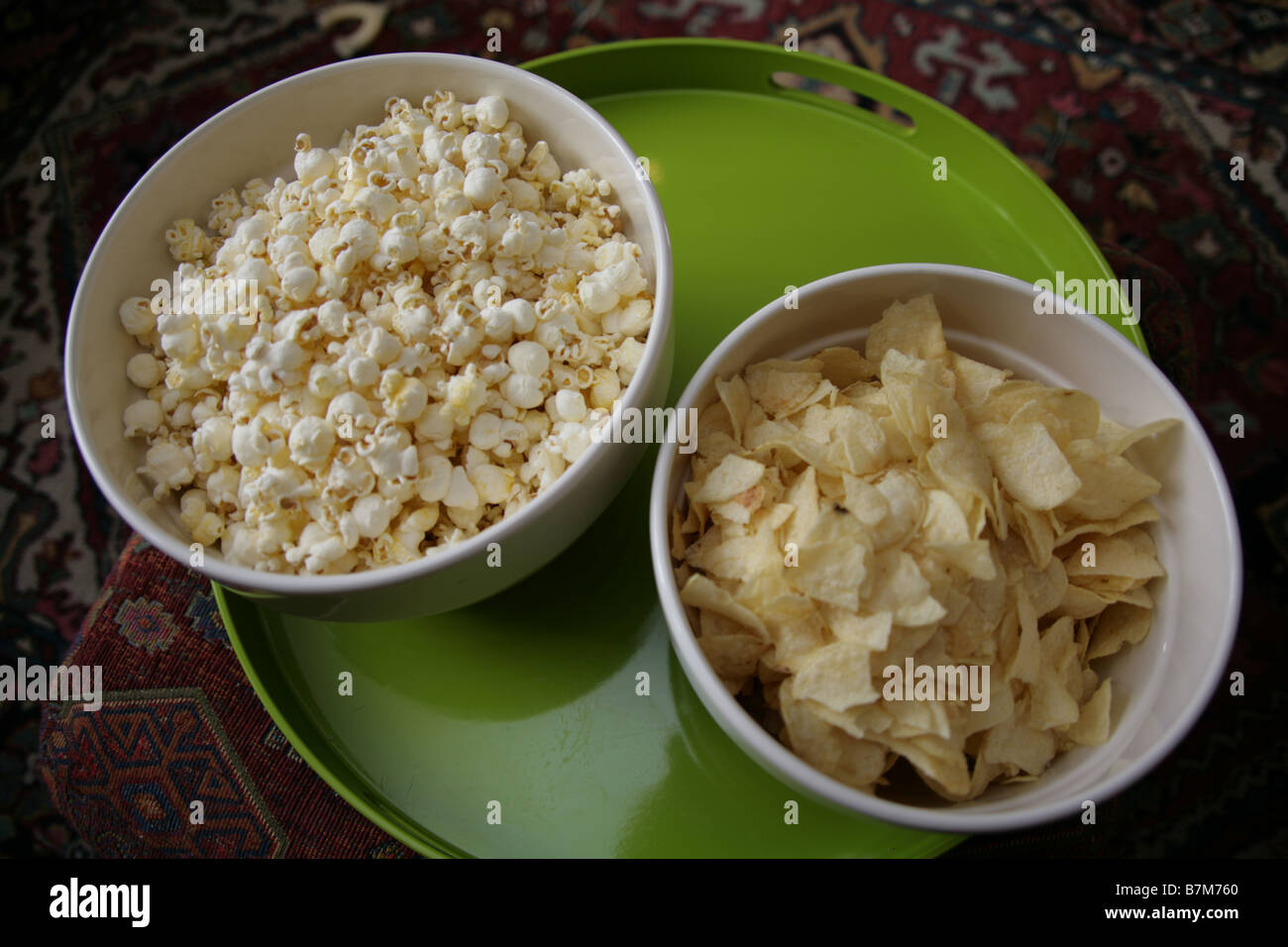Popcorn and potato chips in snack bowls Stock Photo Alamy