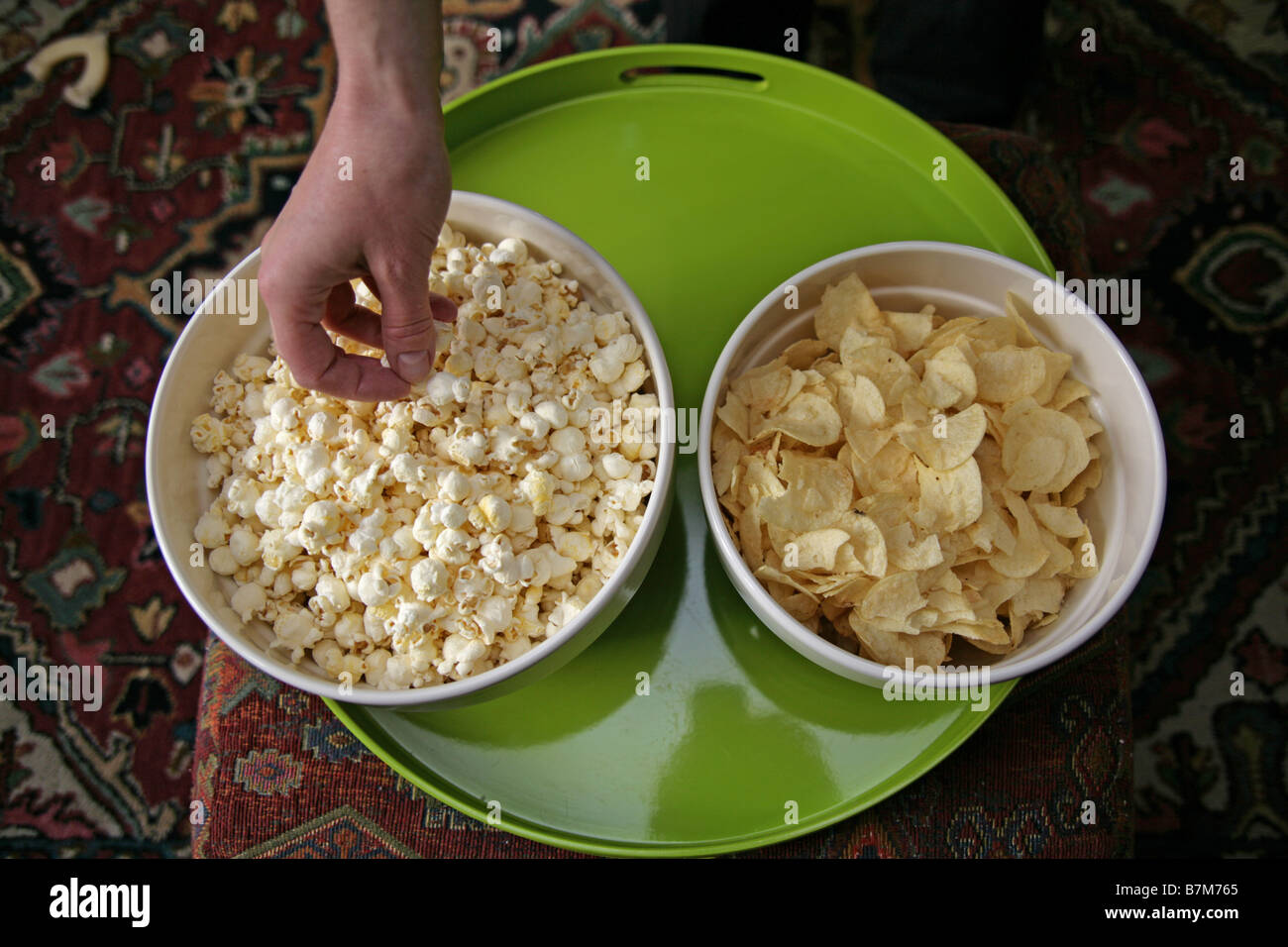 Popcorn and potato chips in snack bowls Stock Photo Alamy