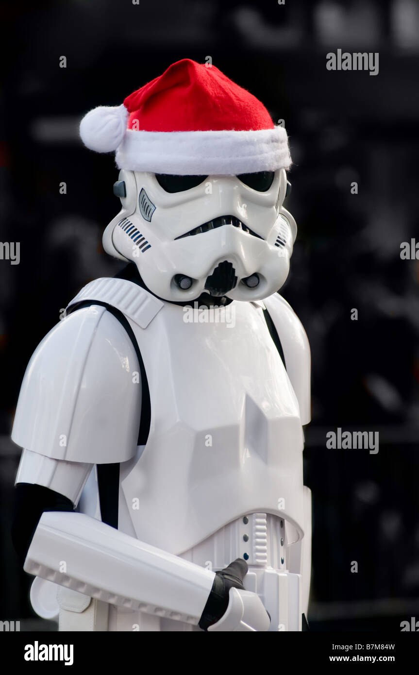 Star Wars Storm Trooper wears a Santa Claus hat while walking in a holiday parade. Stock Photo
