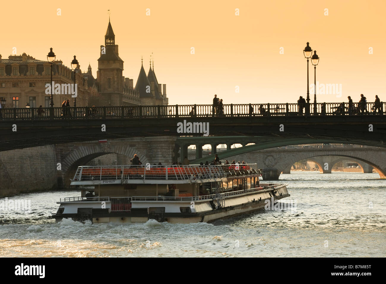 TOUR BOAT ON THE RIVER SEINE PARIS AT SUNSET Stock Photo
