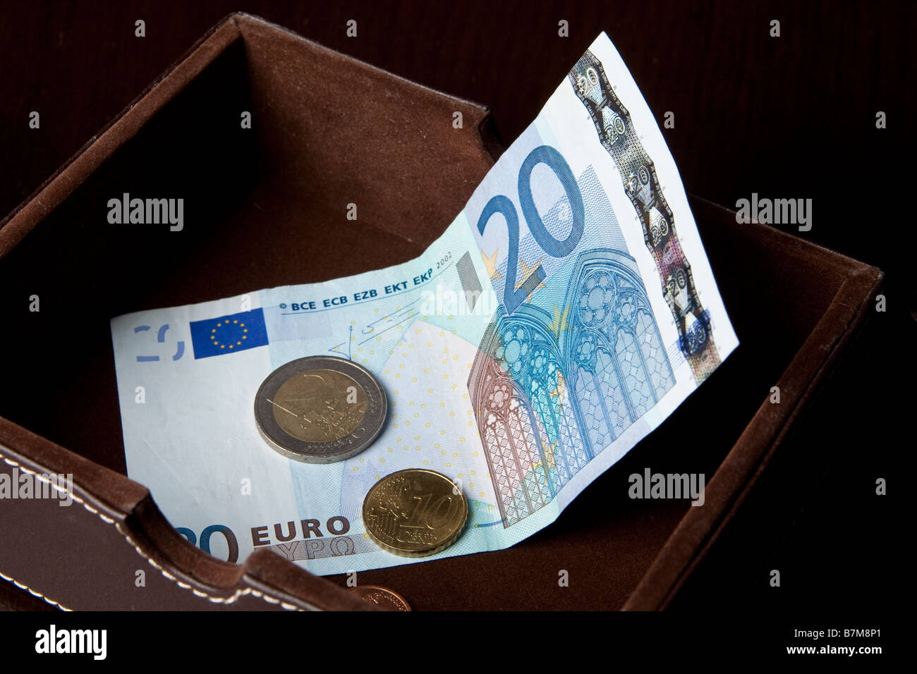 Euro notes and coins in a money box Stock Photo Alamy