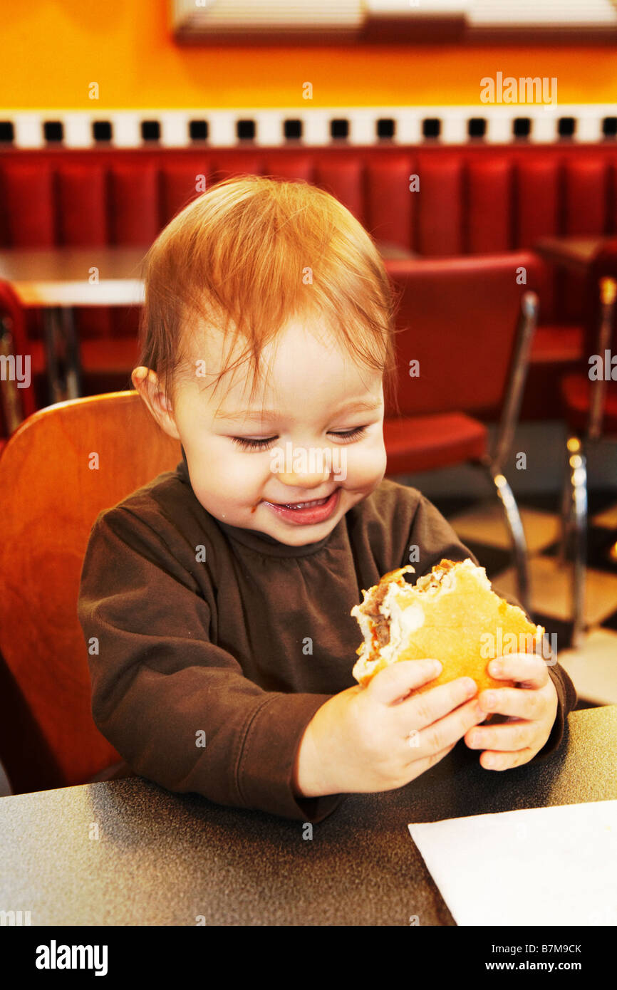 Child 15 Month Old Eating First Hamburger Ever In A Hamburger child-15-month-old-eating-first-hamburger-ever-in-a-hamburger