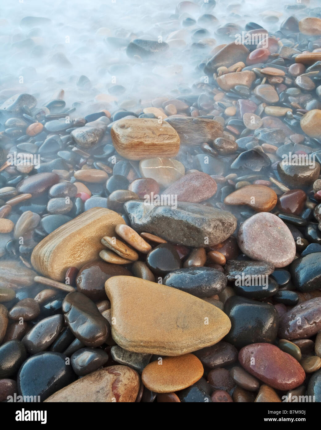 Rocks and pebbles on the beach at Low Hauxley near the village of Amble on the Northumbrian Coast, Northumberland, England Stock Photo