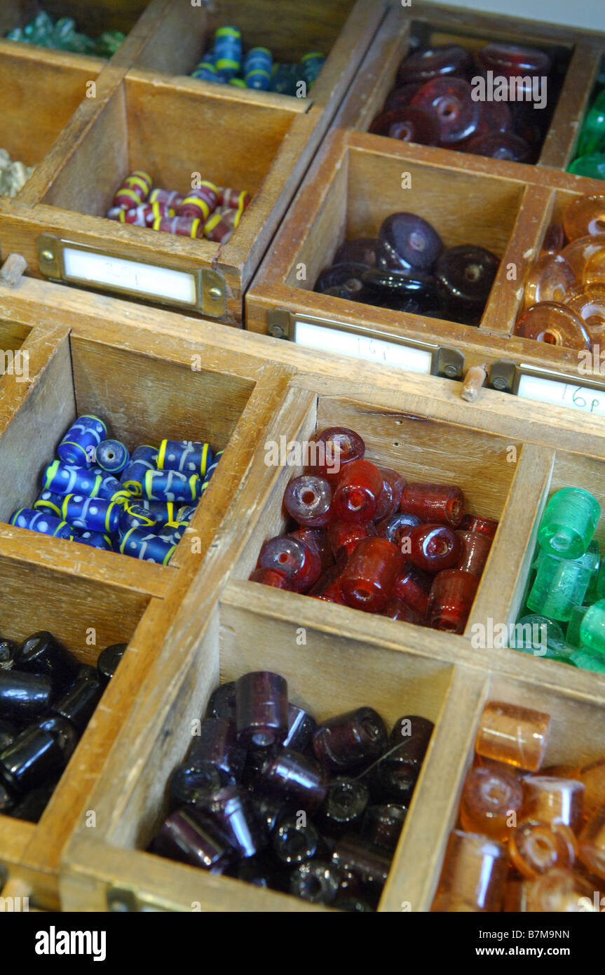 Different coloured colored beads in bead display boxes. Stock Photo