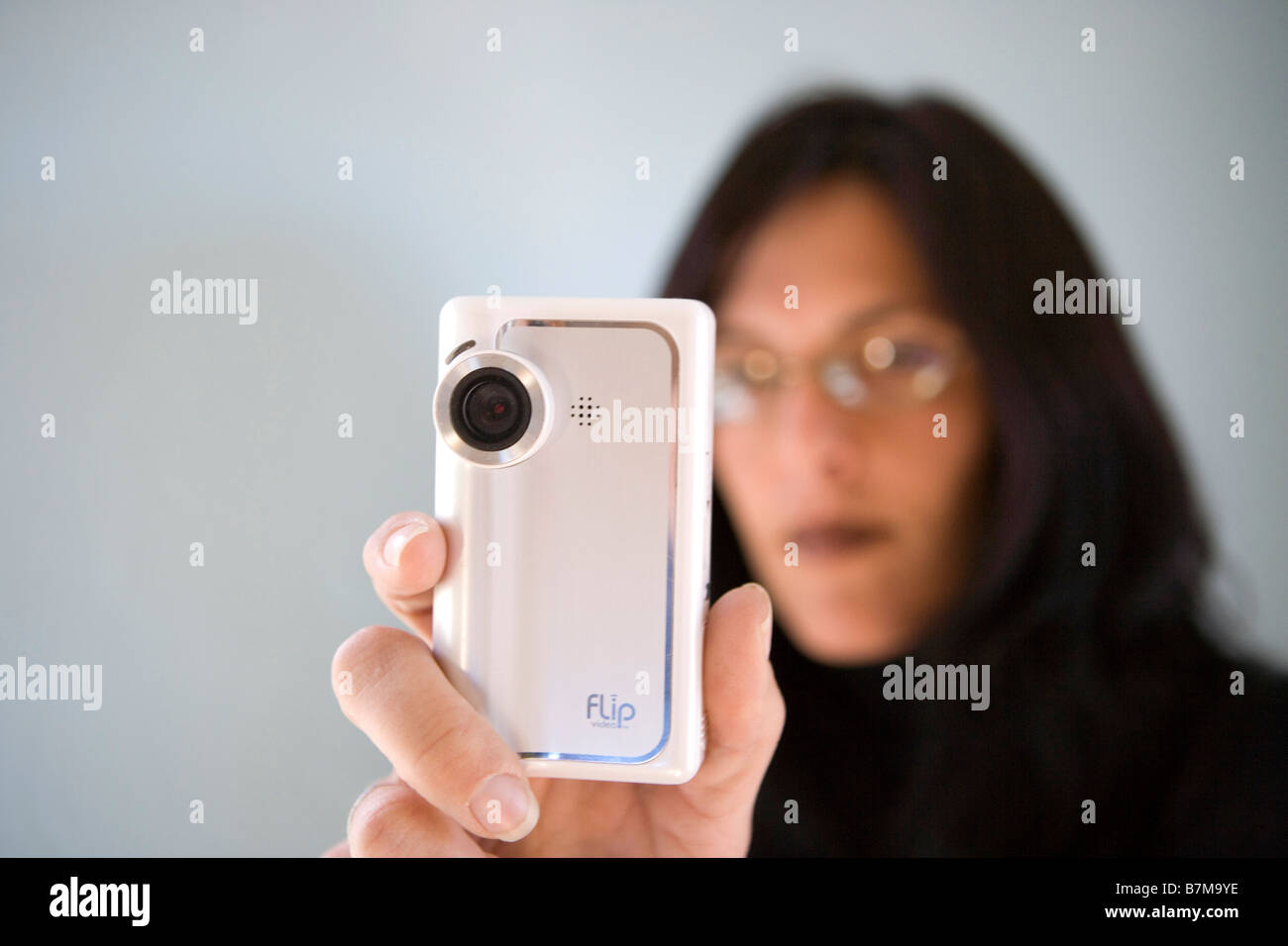 woman in mid thirties video taping using a small flip video camera, closeup shot Stock Photo