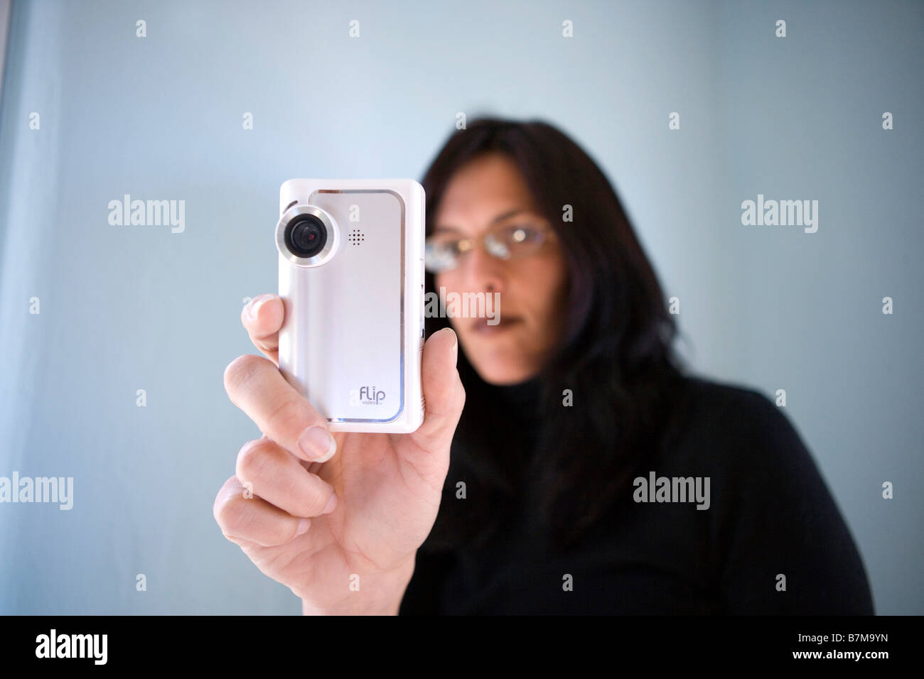 woman in mid thirties video taping using a small flip video camera Stock Photo
