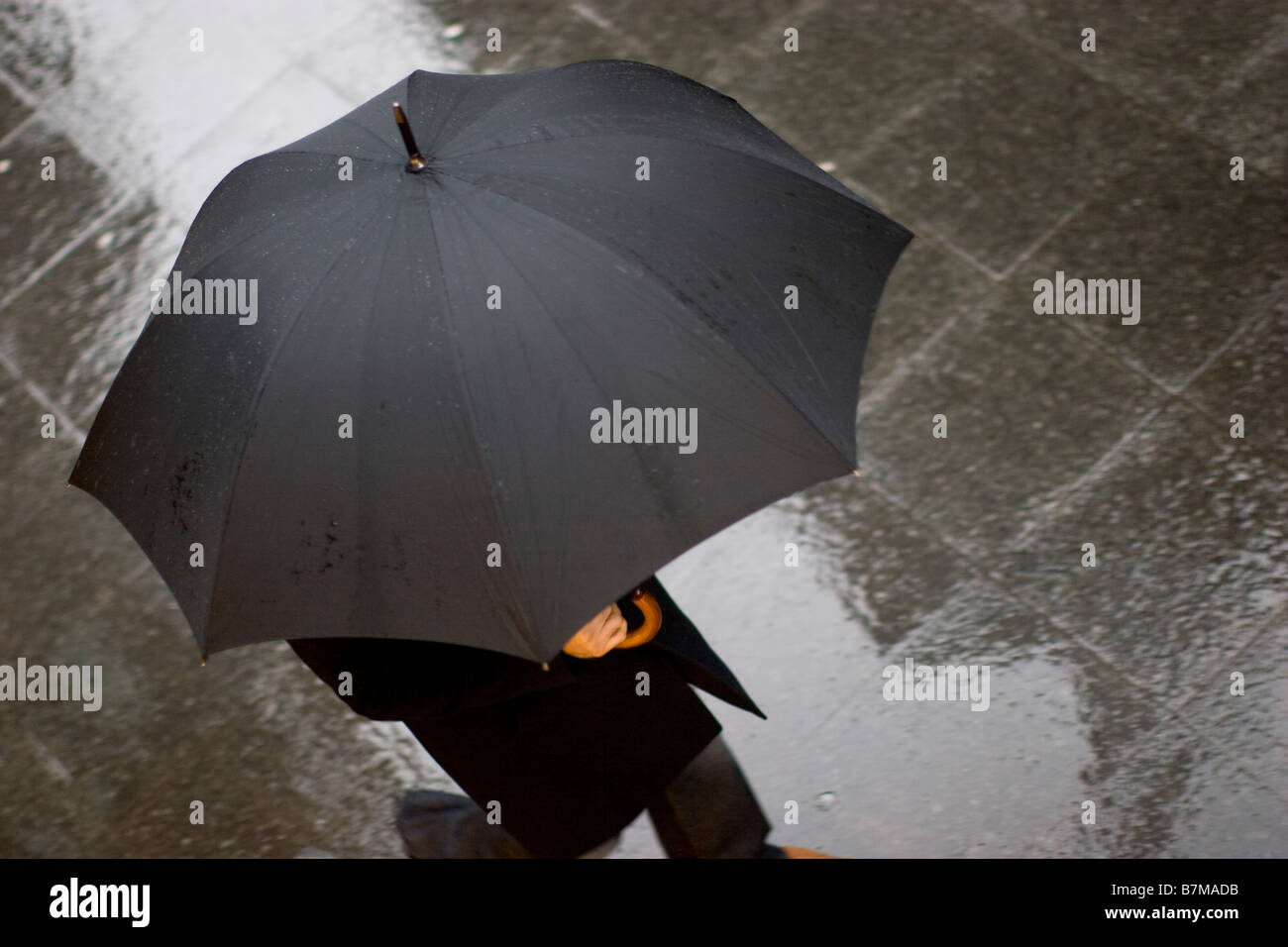 Rain in London financial district man with umbrella on gloomy London morning in rush hour Stock Photo