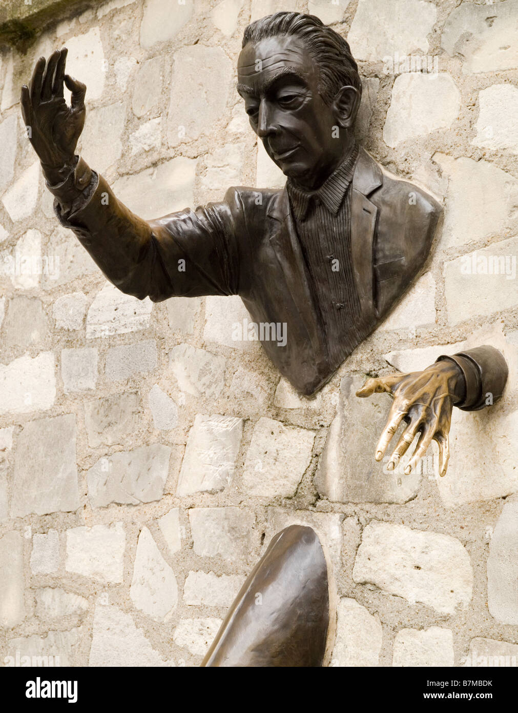 Bronze sculpture embedded in a wall in Montmartre in Paris, dedicated to author Marcel Aymé who wrote the book Le Passe-Muraille Stock Photo