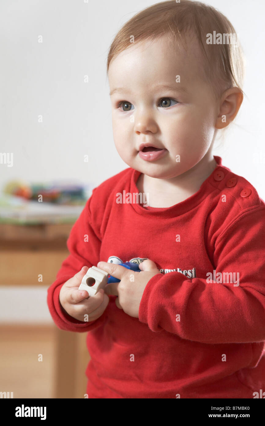 Child (12-18 month) holding toys. Stock Photo