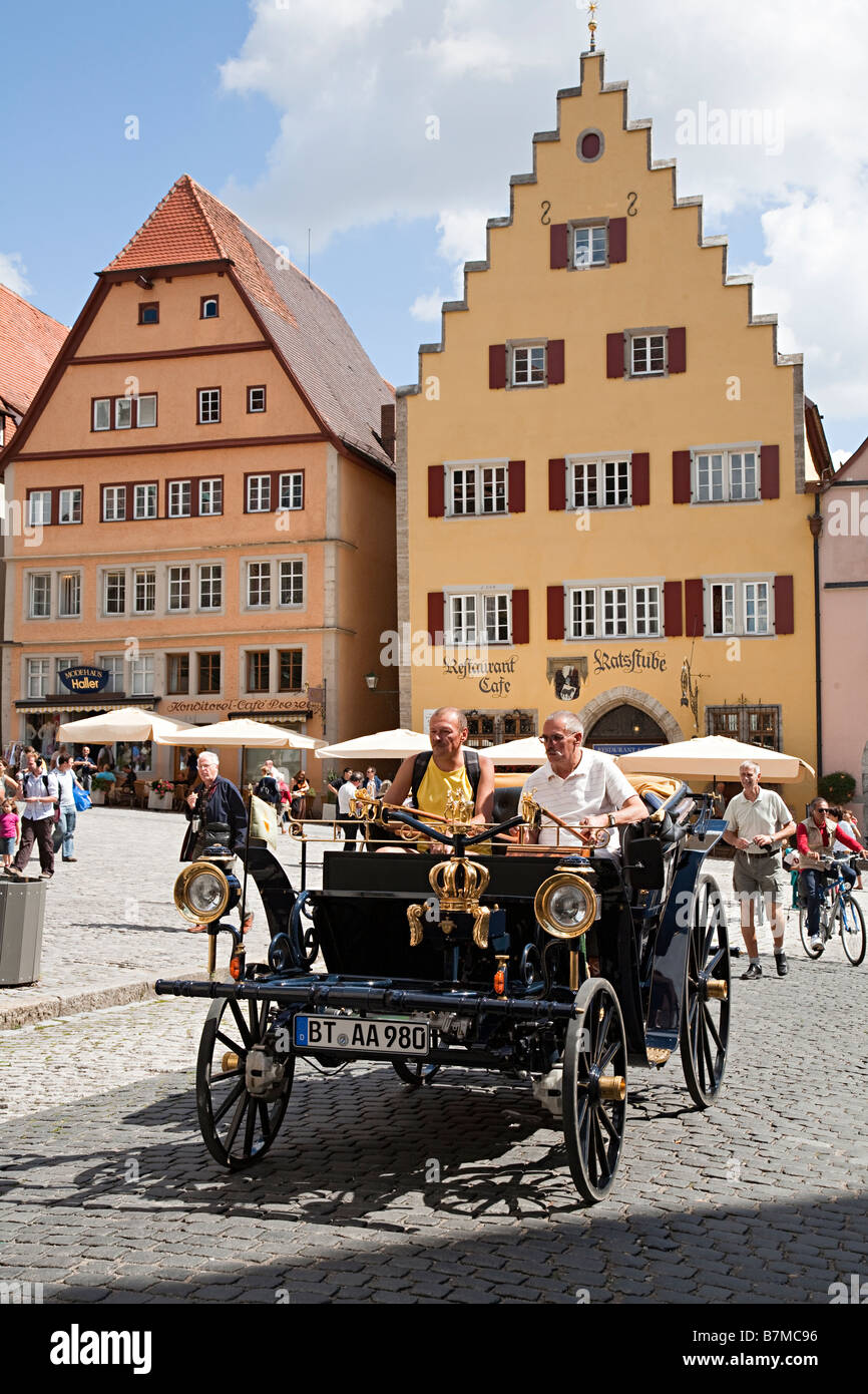 Driving a classic Aaglander car through cobbled streets of Rothenburg Germany Stock Photo