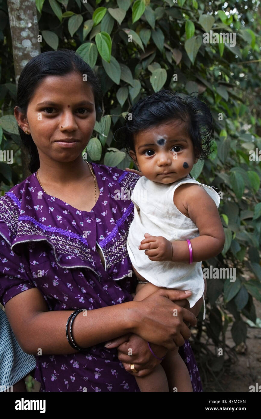 Tribal woman with her child in the tribal village near Kumily in ...