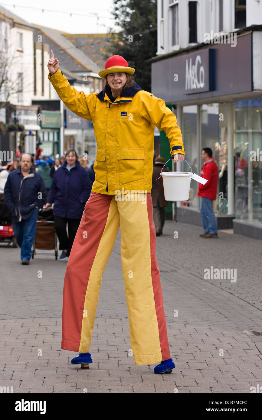 Man on stilts collecting money for RNLI in Littlehampton West Sussex UK