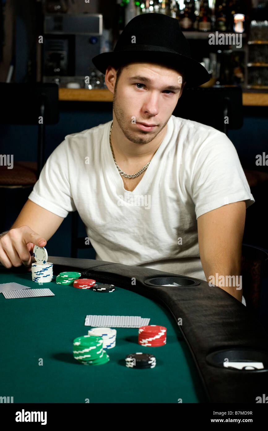 Young man ready to play poker in bar Stock Photo Alamy