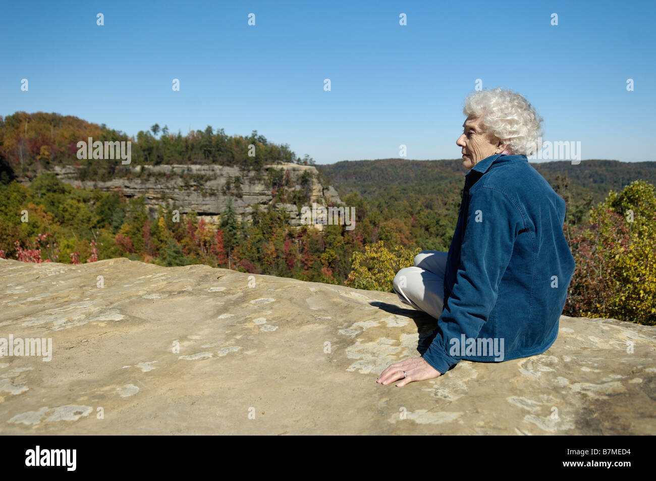 Senior Woman on Top of Natural Bridge in Natural Bridge State Park Kentucky Stock Photo