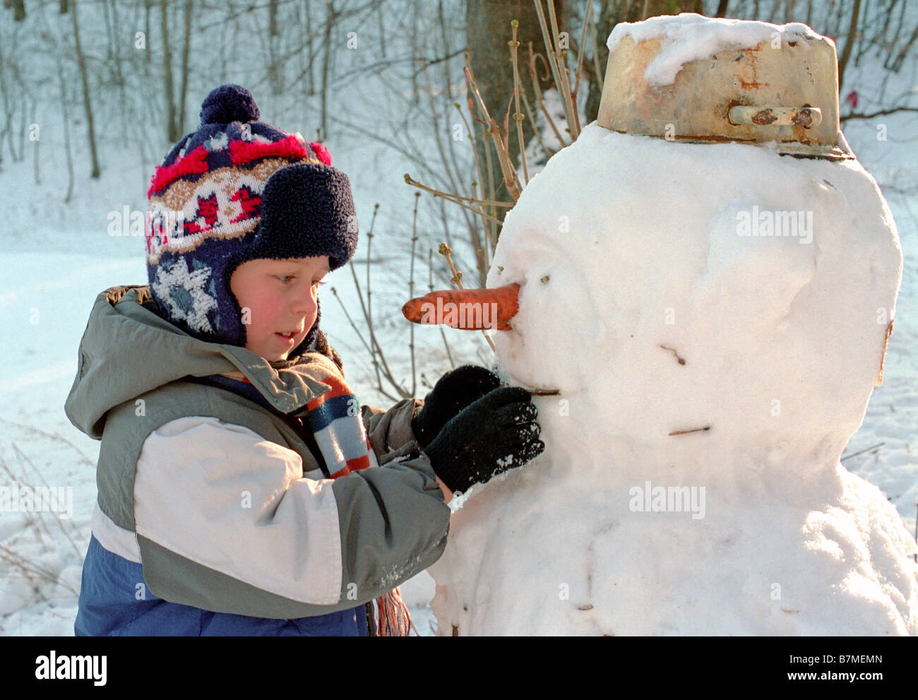 little boy and snowman Stock Photo