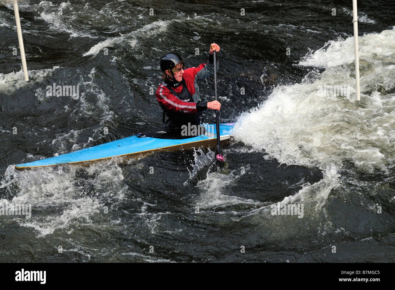 man paddling  in turbulent water in a canoe Stock Photo