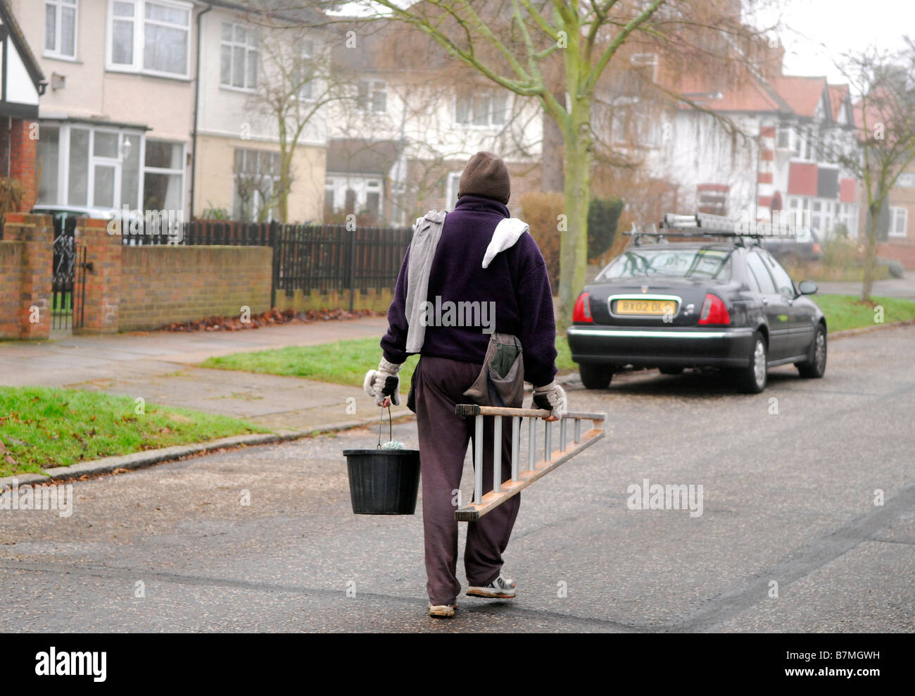 Window cleaner doing his rounds along a residential street, Hounslow