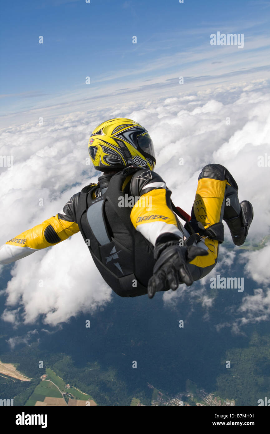 Skydiver is riding his motor bike clothes through the sky and having a ...
