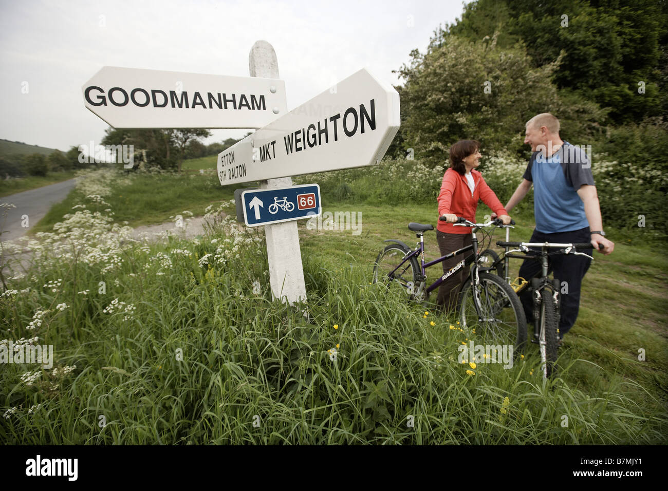 Couple cycling route 66 near Market Weighton The Wolds East Yorkshire UK Stock Photo