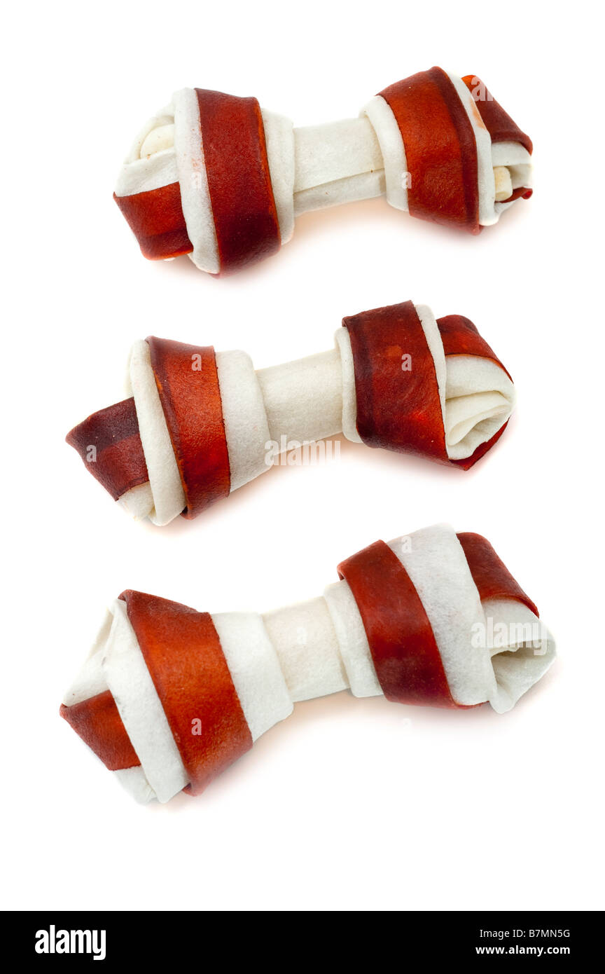 Three 3 cowhide dog chew bones Stock Photo Alamy