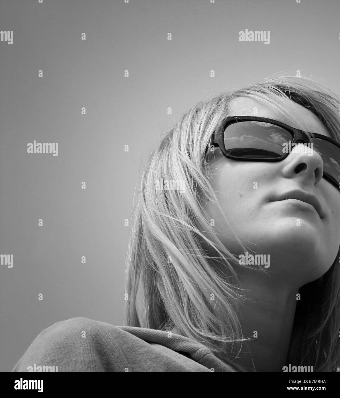Happy woman against blue sky Stock Photo - Alamy