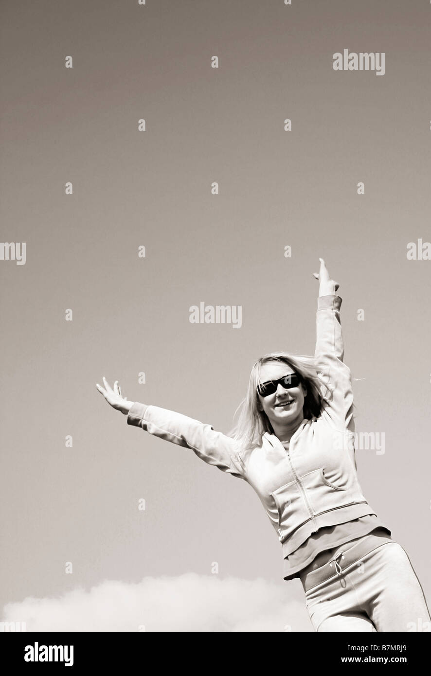 Happy girl jumping against the sky Stock Photo - Alamy