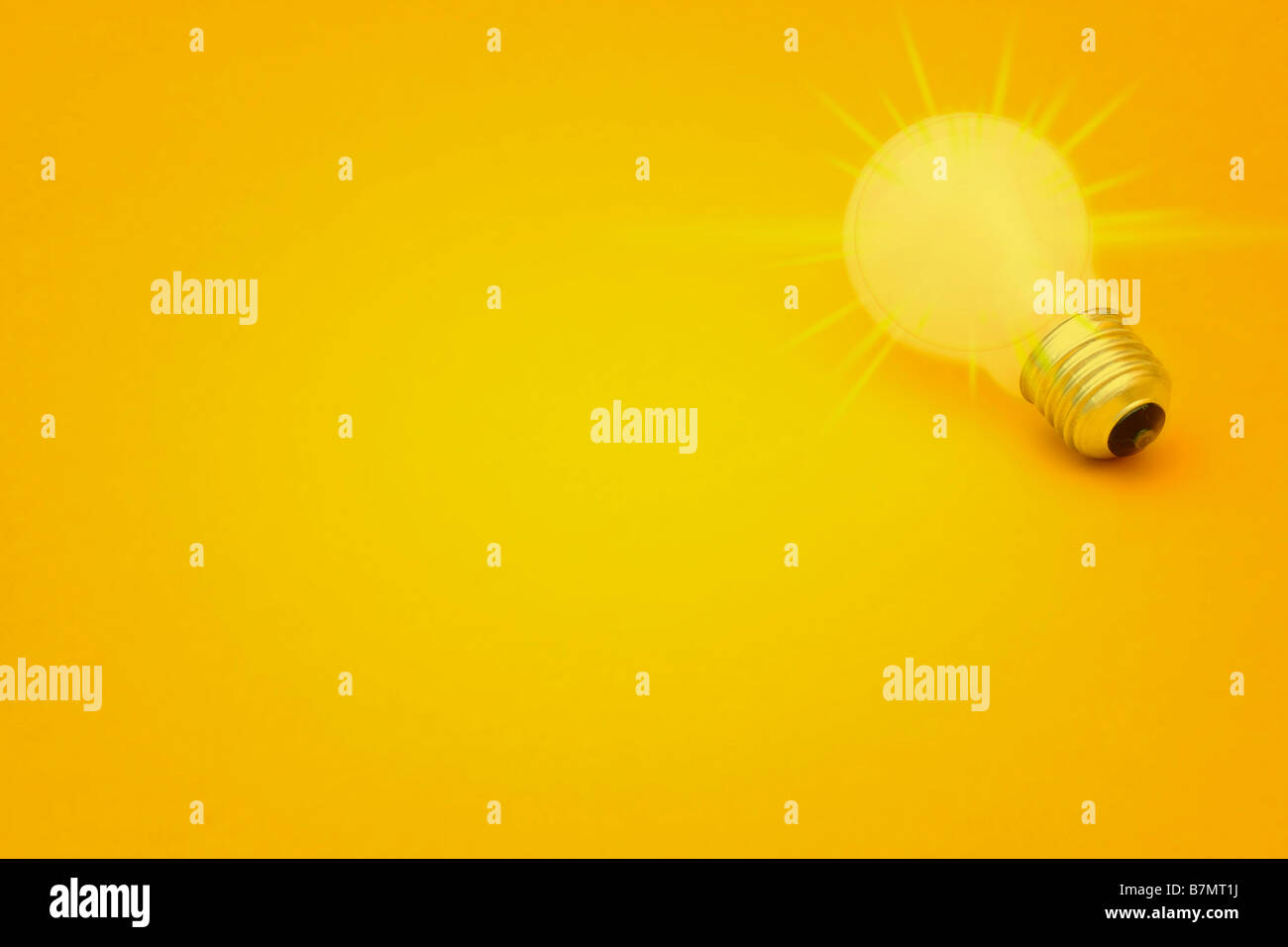 Background with lit lightbulb on yellow Stock Photo - Alamy