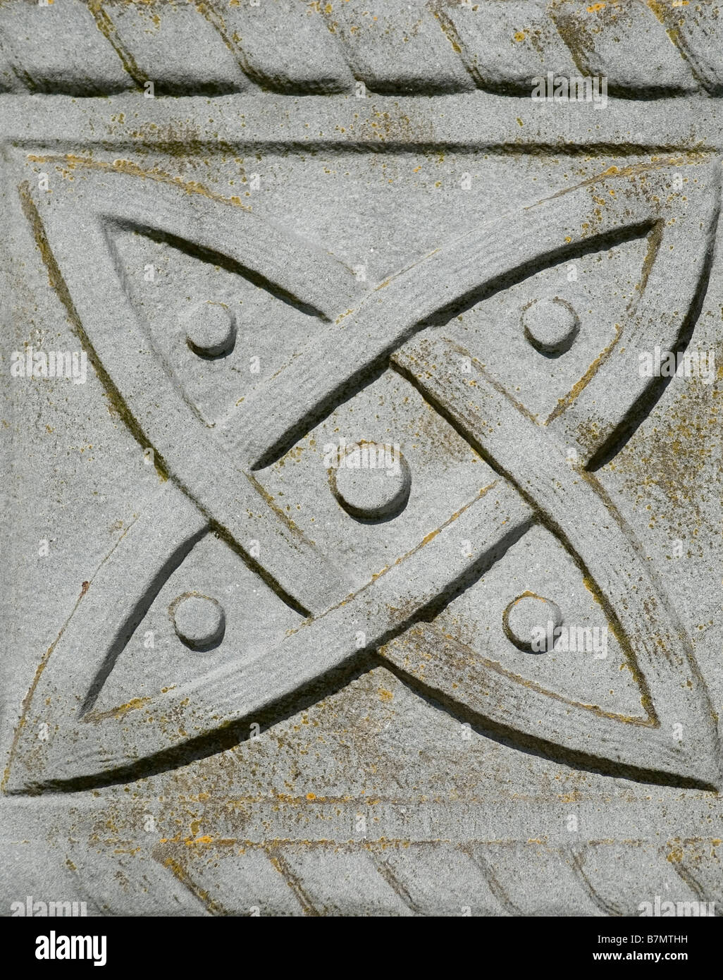 Closeup of a Celtic Tombstone with a Trinity Knot Symbol at Graveyard at Rock of Cashel Castle, Ireland Stock Photo