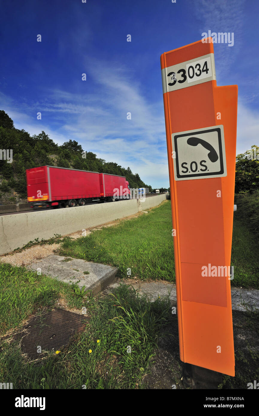 A heavy goods vehicle passes an SOS telephone on a French autoroute  motorway freeway Motion blur on the vehicle Stock Photo - Alamy