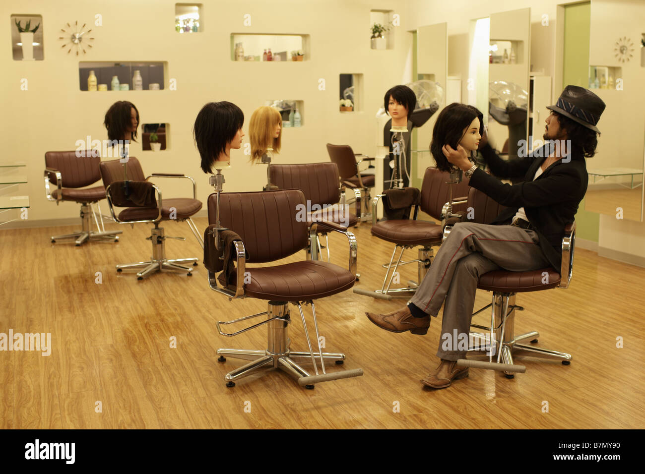 Man and Wigs in Hair Salon Stock Photo Alamy