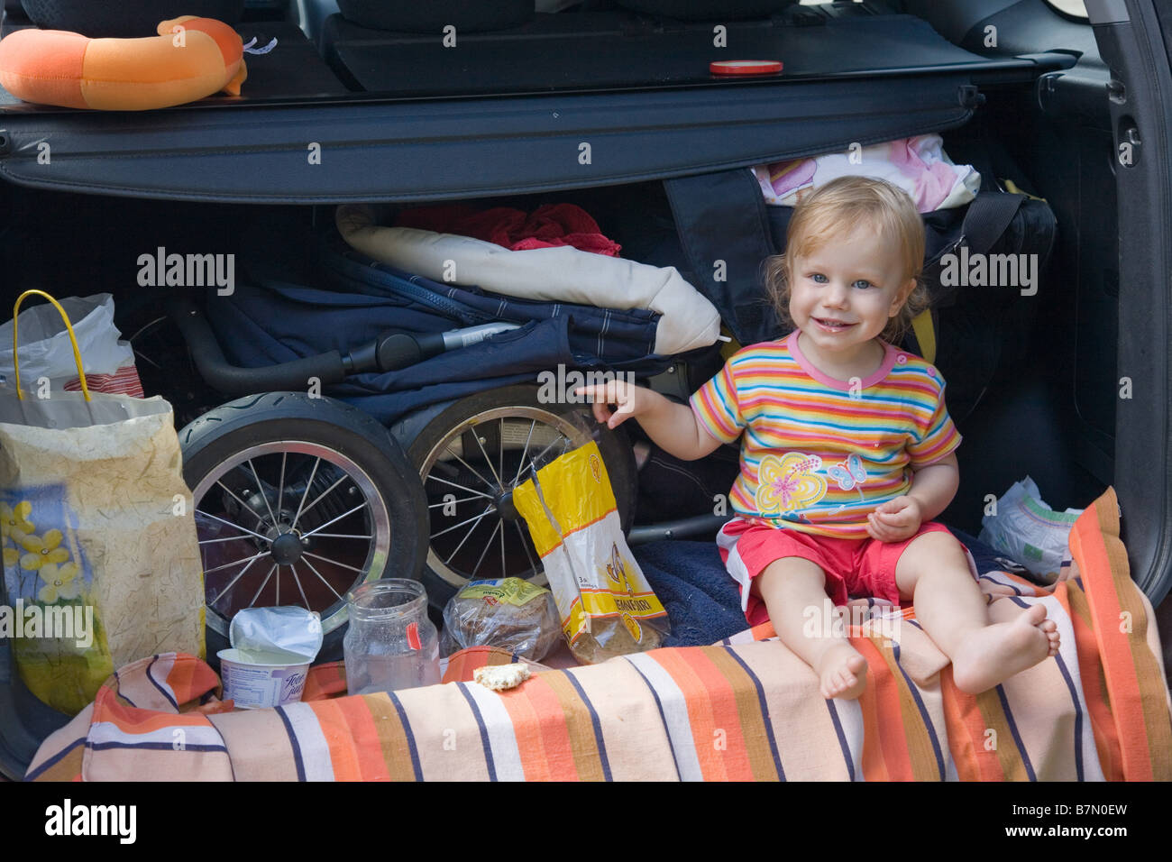One Year Old Baby Sitting in Car Stock Photo