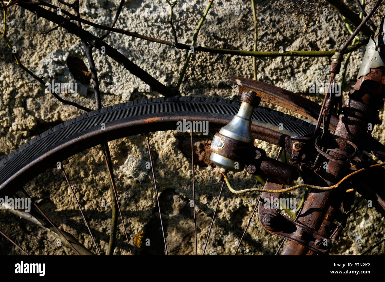 Stock photo of a very old rusty bike left leaning against a wall Stock Photo